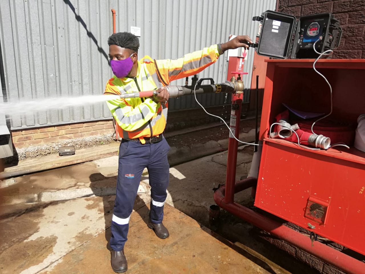 KNS Fire technician conducting fire hydrant flow and pressure test using calibrated test gauge